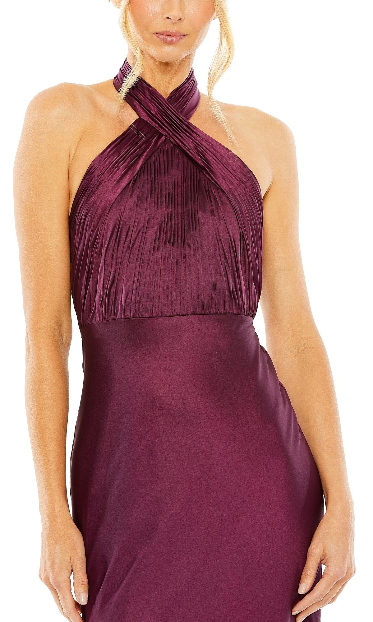 A woman poses with her arms relaxed at her sides, wearing the Mac Duggal 55995 long formal dress—a sleeveless gown in a rich plum shade, featuring a halter neckline with delicate pleats and a fitted satin skirt. This elegant look is perfect for special occasions.